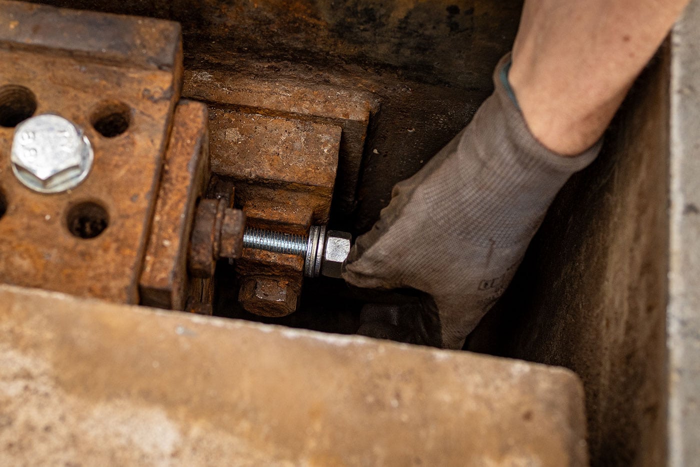 Person repairs machine with tools