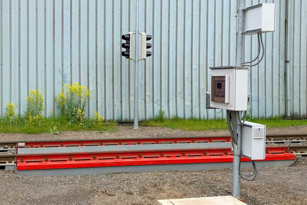 Railroad track with signal system and metal fence